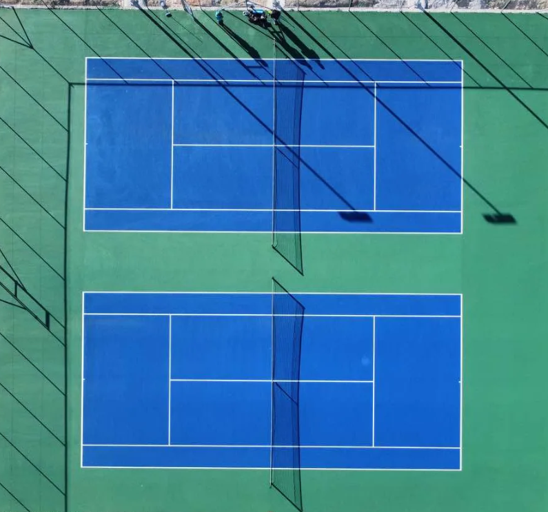 Aerial view of two blue tennis courts