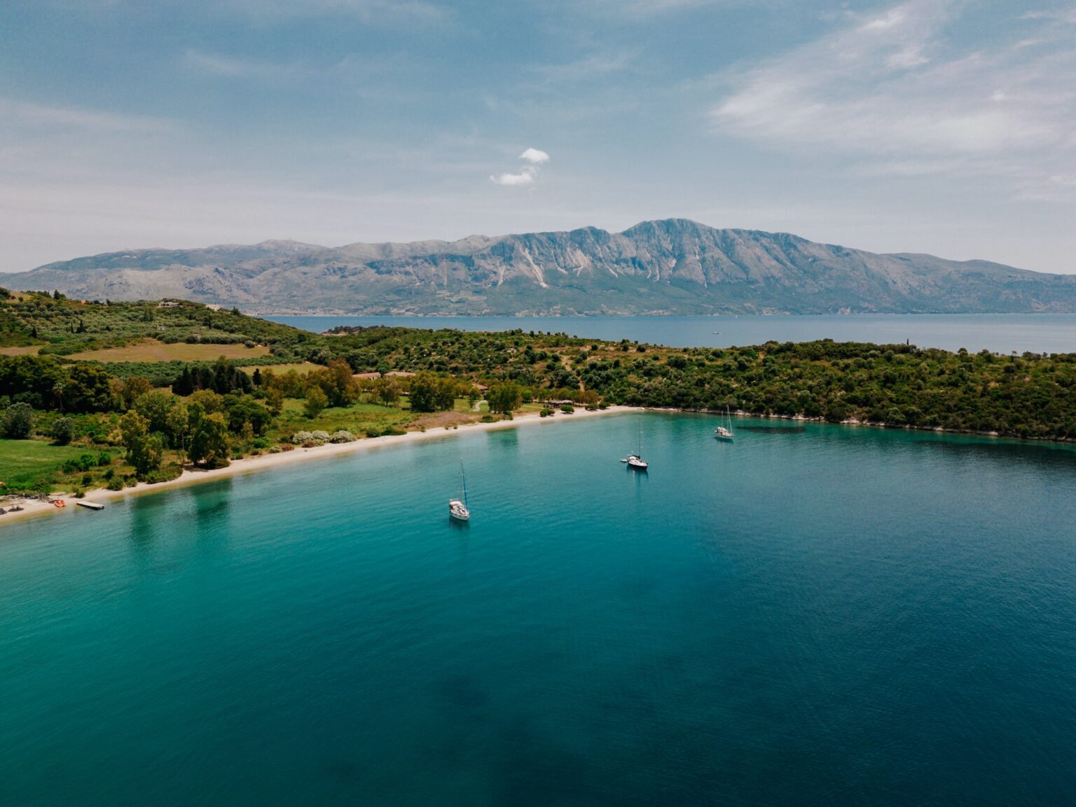 Aerial view of turquoise coastline and hidden coves near Paleros, Greece