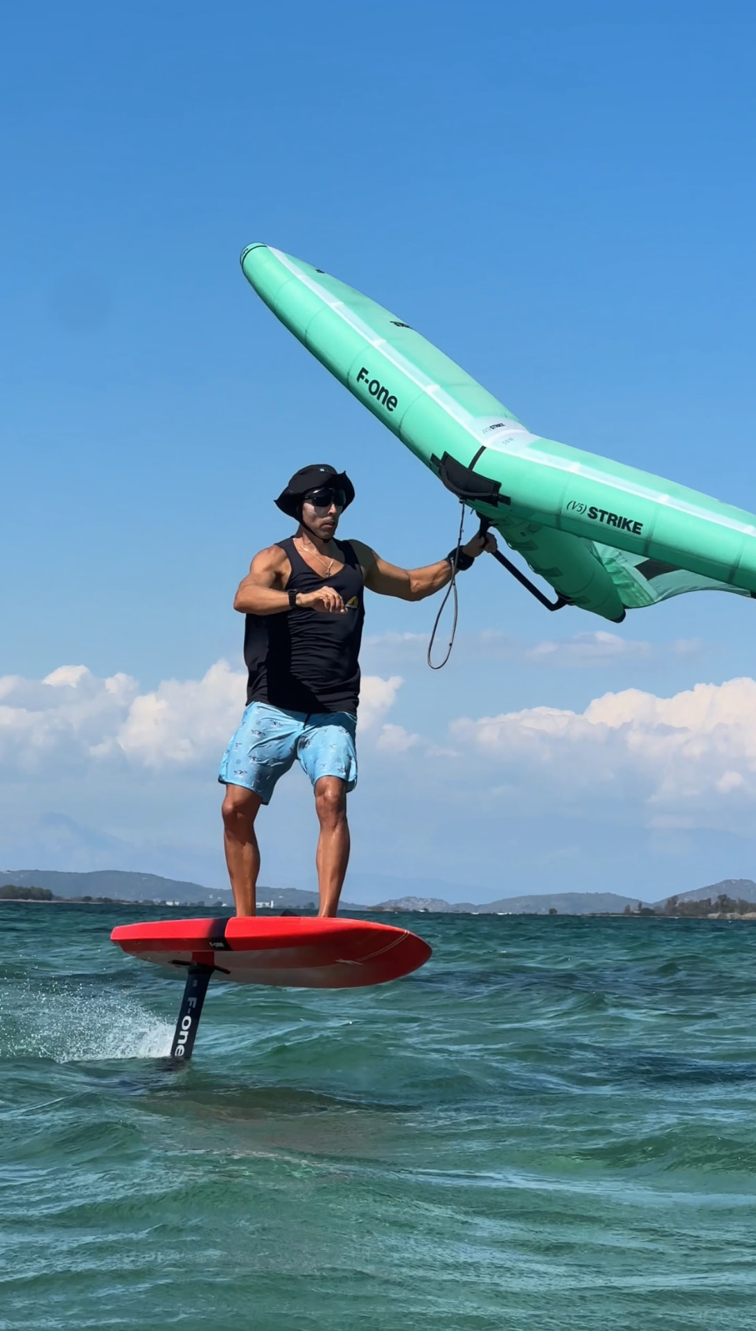 Wing foiling on the turquoise water off Paleros