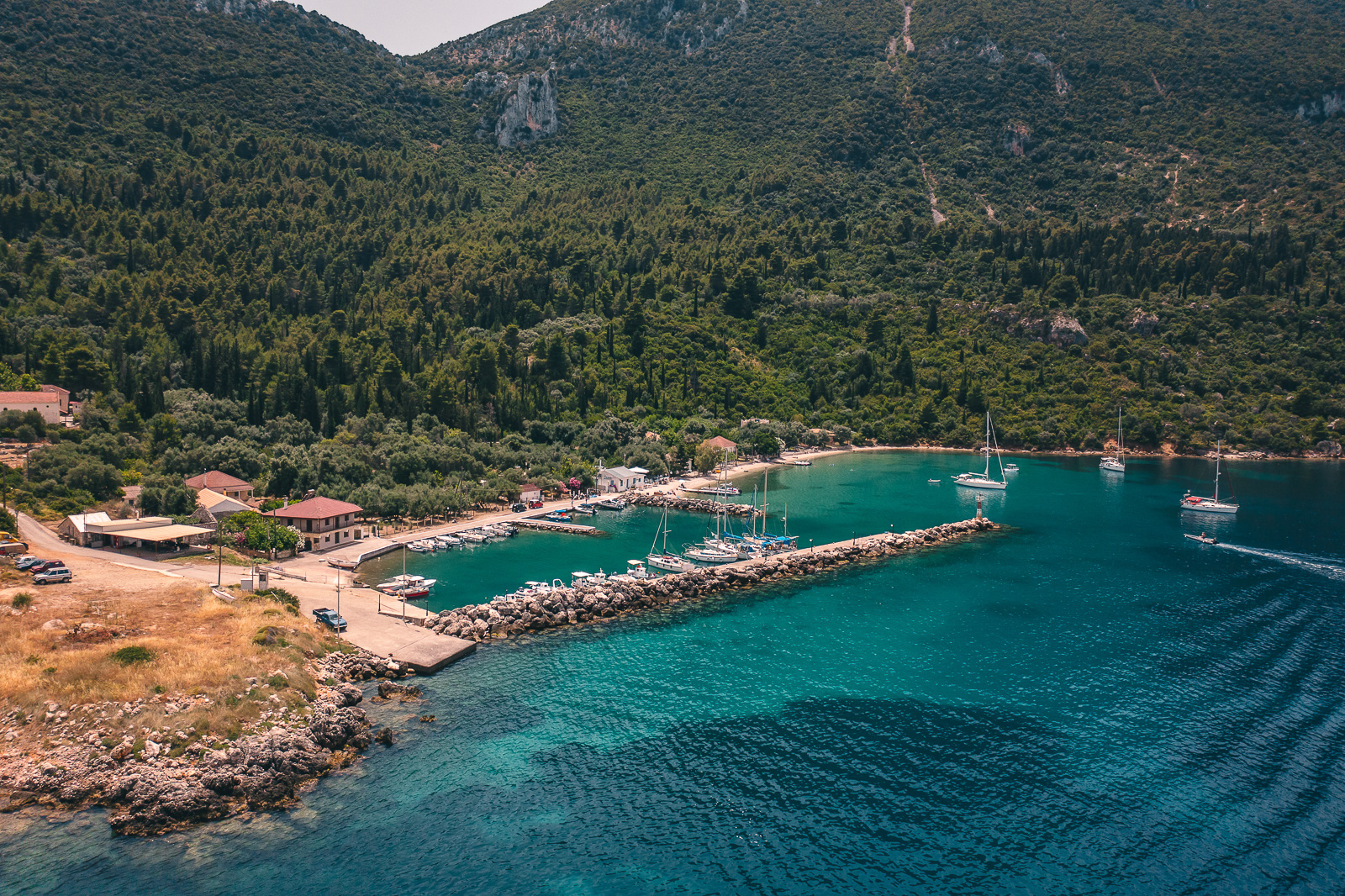 Aerial view of the harbour and village of Kalamos below green hills